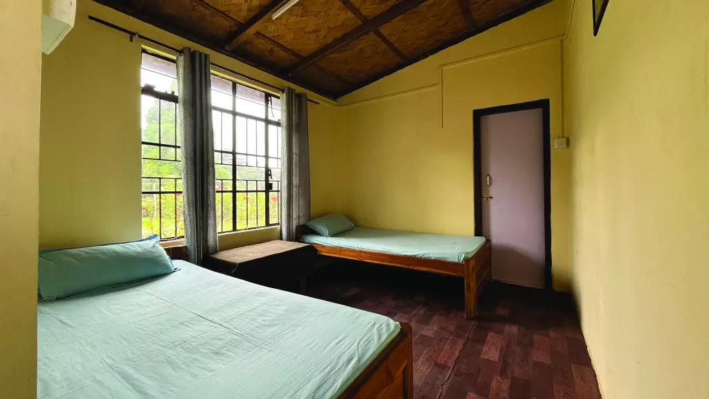 Room 3 with two beds by large windows