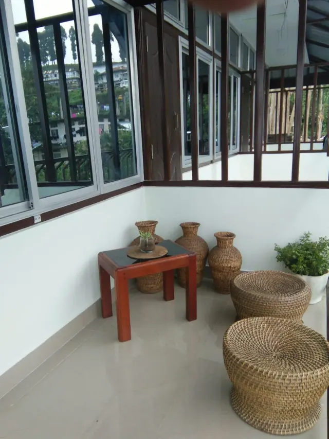 Sitting corner with cane stools and clay pots by the windows