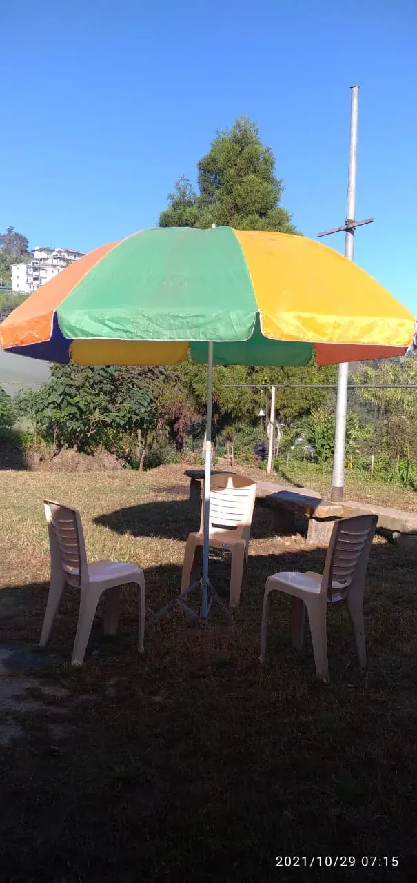 Garden table and chairs under a colourful umbrella