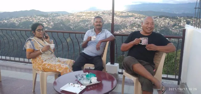 Guests having tea on the balcony overlooking Kohima town