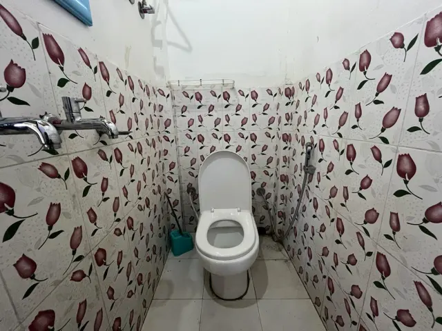 Attached bathroom of Room 4 with floral tiles