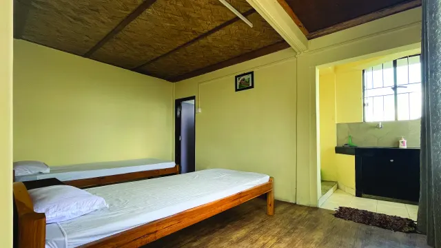 Room 2 with two beds and a doorway to the kitchen