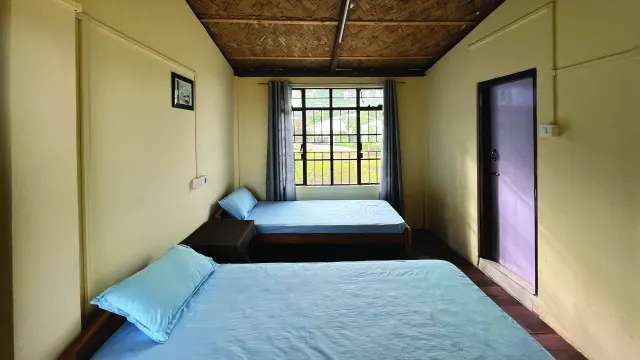 Room 4 with two beds and a wooden ceiling